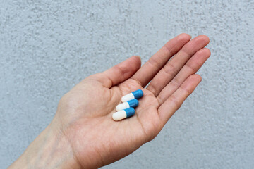 Hand holding pills - Medicine, prescription drugs