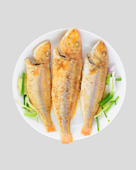 Three fried fish on the plate.