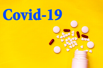white tablets on yellow background. top view