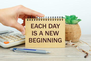 Notebook with text - Each day is a new beginning