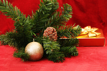Christmas and New Year gifts as a symbol of New Year and Christmas.  Christmas festive decor with tree, candle, gifts on a red background.