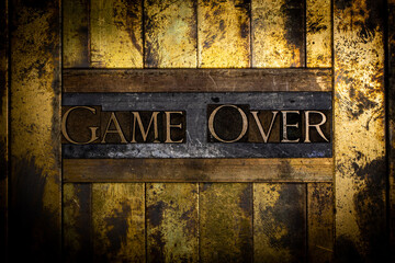 Game Over text message on textured grunge copper and vintage gold background