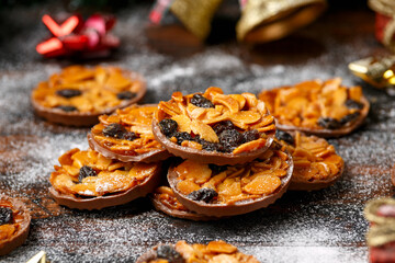 Christmas Chocolate Florentines cookies with almond and raisins with decoration, gifts, green tree...