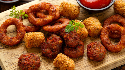 Fried Buffalo onion rings, tater tots and sweetcorn fritters with ketchup and beer. Party take away food