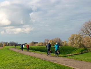 Dutch people cycle on dike