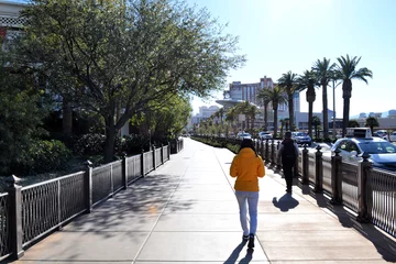 Fotobehang Woman in yellow jacket walking around Las Vegas, Nevada, US © Marta