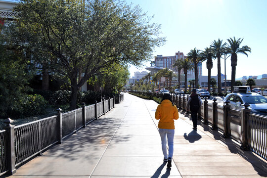 Woman in yellow jacket walking around Las Vegas, Nevada, US
