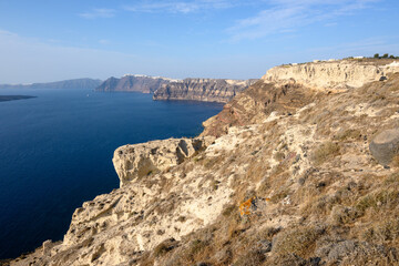 Fototapeta na wymiar The coast of Santorini Island in Greece, impressive volcanic cliffs and a view of the caldera. Cyclades Islands
