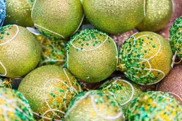 Green Christmas decorations in box. Colorful baubles in the white box. toned