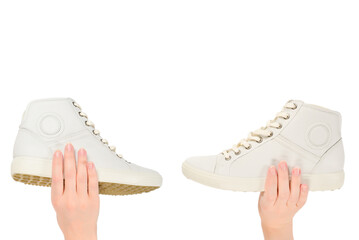 White leather shoes in woman hand isolated on white.