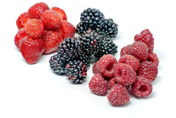 assorted piles of forest fruits on white