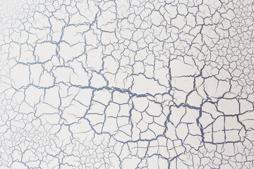 White color with cracks on the cement wall, texture