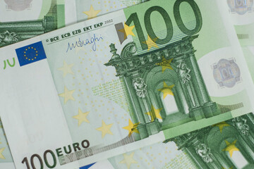100 euro bill. Europein money banknote. Hundred euro bills on wooden background..