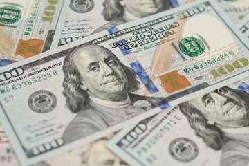 Obraz na płótnie Canvas 100 Dollars bill and portrait Benjamin Franklin on USA money banknote. Hundred dollar bills on wooden background..