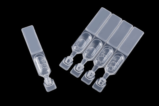 Pack of artificial tear single use containers isolated on black. Eye care concept. dry eye treatment
