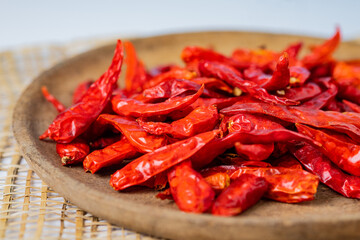 Dry chillies in wooden bowl on table closeup shots