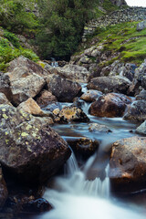 Naklejka na ściany i meble Long exposure landscape of a gentle stream flowing down the hillside in the Lake District