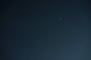 Crescent moon with empty blue sky copy space for banner or wallpaper background