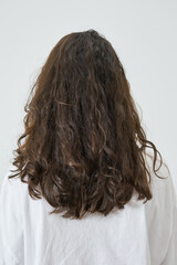 Dry and frizzy natural curly hair that needs hydration. Natural curls before salon treatment. close up, soft focus - 394395359