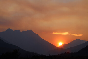 Sunset through forest fire smoke, Waterton Alberta Canada