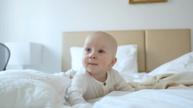 portrait of toddler boy in bed