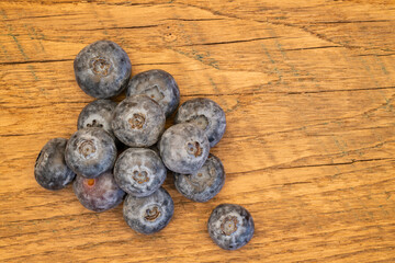 handful of fresh blueberries on a farm table