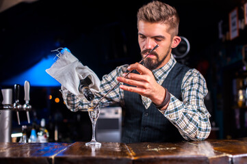Barman makes a cocktail in the beerhouse