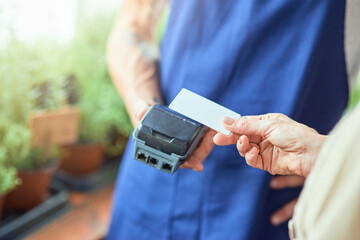 Woman paying contactless with credit card in shop