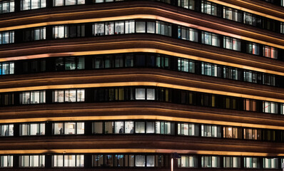 office building facade - business people working at night