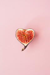 Figs in the form heart isolated on pink background. Fruit illustration. Food photo background. Flat...