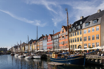Scenic summer view of Nyhavn pier with colorful buildings and boats in Old Town of Copenhagen, Denmark