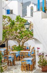 Cycladitic alley with narrow street and  an exterior of a traditional  tavern  in Marpissa Paros island, Greece.