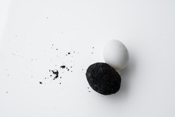 Fototapeta na wymiar An old duck egg recipe in ash. Salty pickled duck egg in ash on a white background