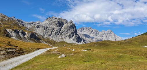 Fototapeta na wymiar The gravel road trekking path in the italien alps, summer 2020