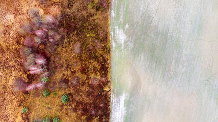 Natural landscape. Forest, field and frozen river background. Aerial view. Autumn landscape taken from the top view drone.