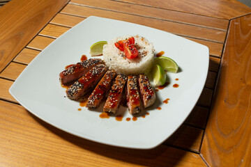 Fried salmon and rice served on white plate