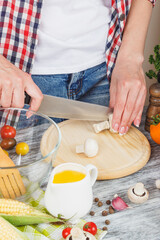 Woman cooks at the kitchen, body part, blured background