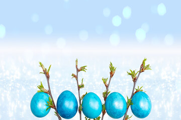 Naklejka na ściany i meble Easter blue eggs on a light blue sparkling background with bokeh