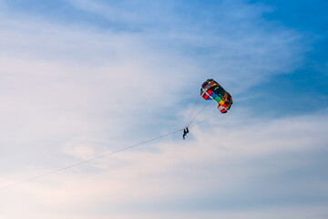 Parasailing in blue sky. Sports, active leisure, travel, vacation concept
