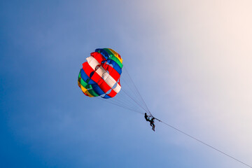 Parasailing in blue sky. Sports, active leisure, travel, vacation concept