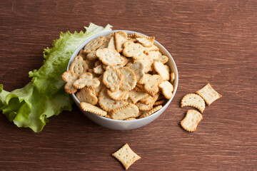 delicious dry cookies, biscuits, crackers with salt and herbs in a clay bowl