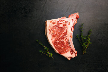 Raw fresh meat T-bone beef Steak on black background, top view