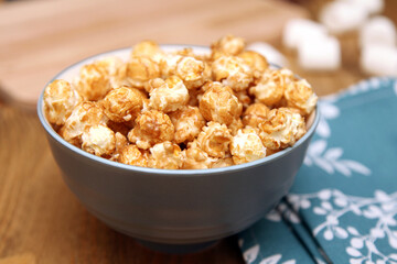 Sweet popcorn in a bowl on background