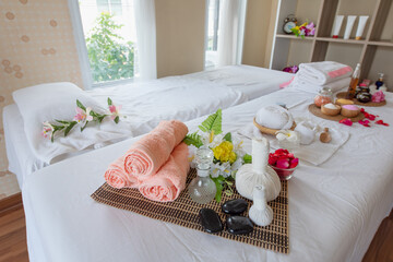 Spa composition in wellness center, Spa treatment set and aromatic massage oil on bed massage