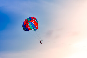 Colorful parachute in the sky on beautiful sunset