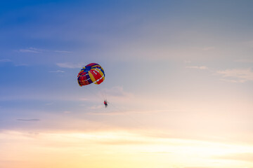 Colorful parachute in the sky on beautiful sunset