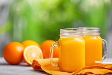 Mason jars of orange fruit on table outdoors