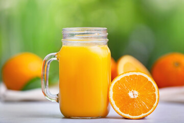 Mason jar of orange fruit on table outdoors