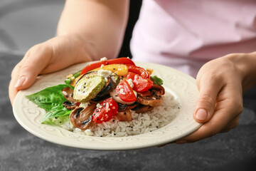 Woman with rice salad, closeup