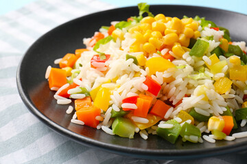 Plate of delicious rice salad with vegetables, closeup